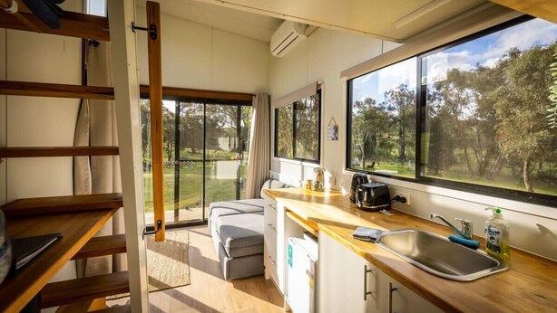 A compact kitchen with a window, a sink, and a toaster.