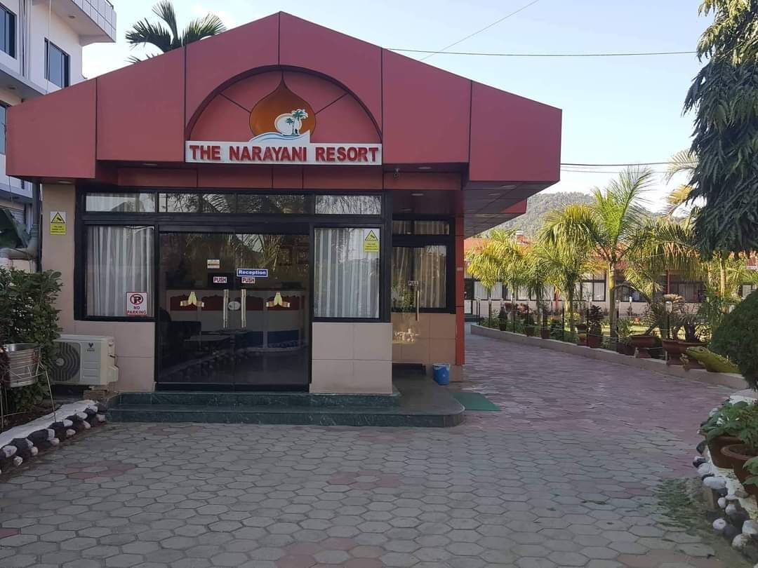 The Narayani Resort with a reception area, a no parking sign, and a paved entrance.