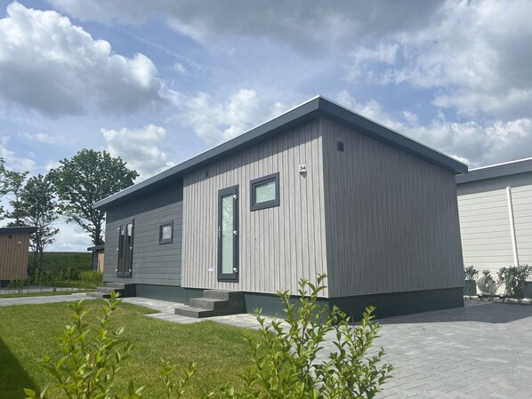 A modern single-story building with a grey exterior and a flat roof.