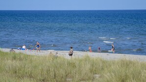 A beach with people enjoying the water and sand.