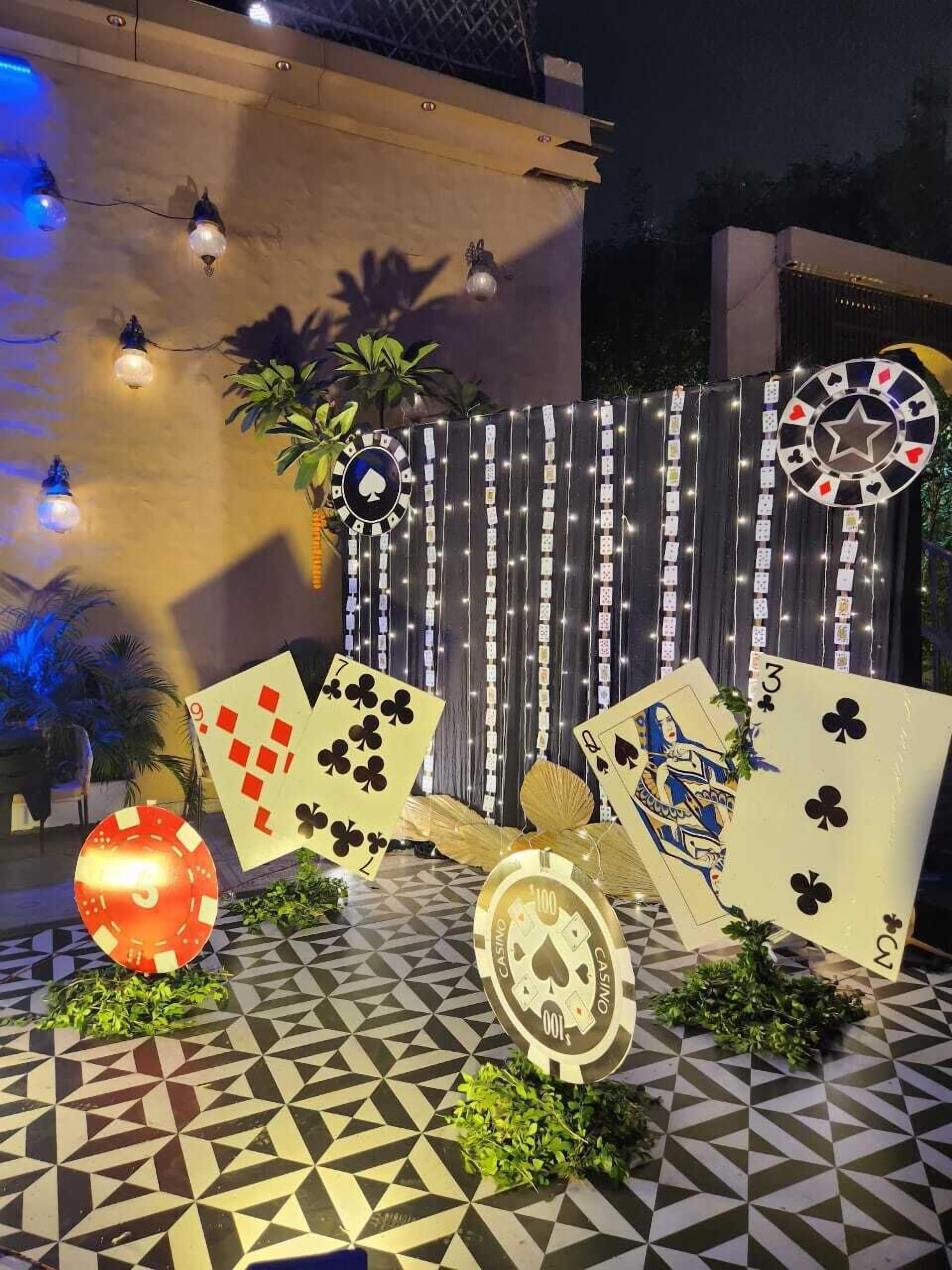 A casino-themed outdoor area with playing cards, casino chips, and a roulette wheel.
