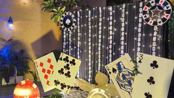 A casino-themed outdoor area with playing cards, casino chips, and a roulette wheel.