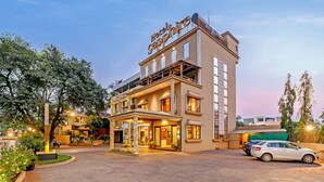 A multi-story hotel with a prominent sign reading "Hotspice". - Hotel Sapphire  (Mawal)