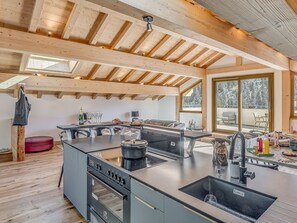 Enjoy cooking and dining in this spacious kitchen with a large island, stove, and oven.