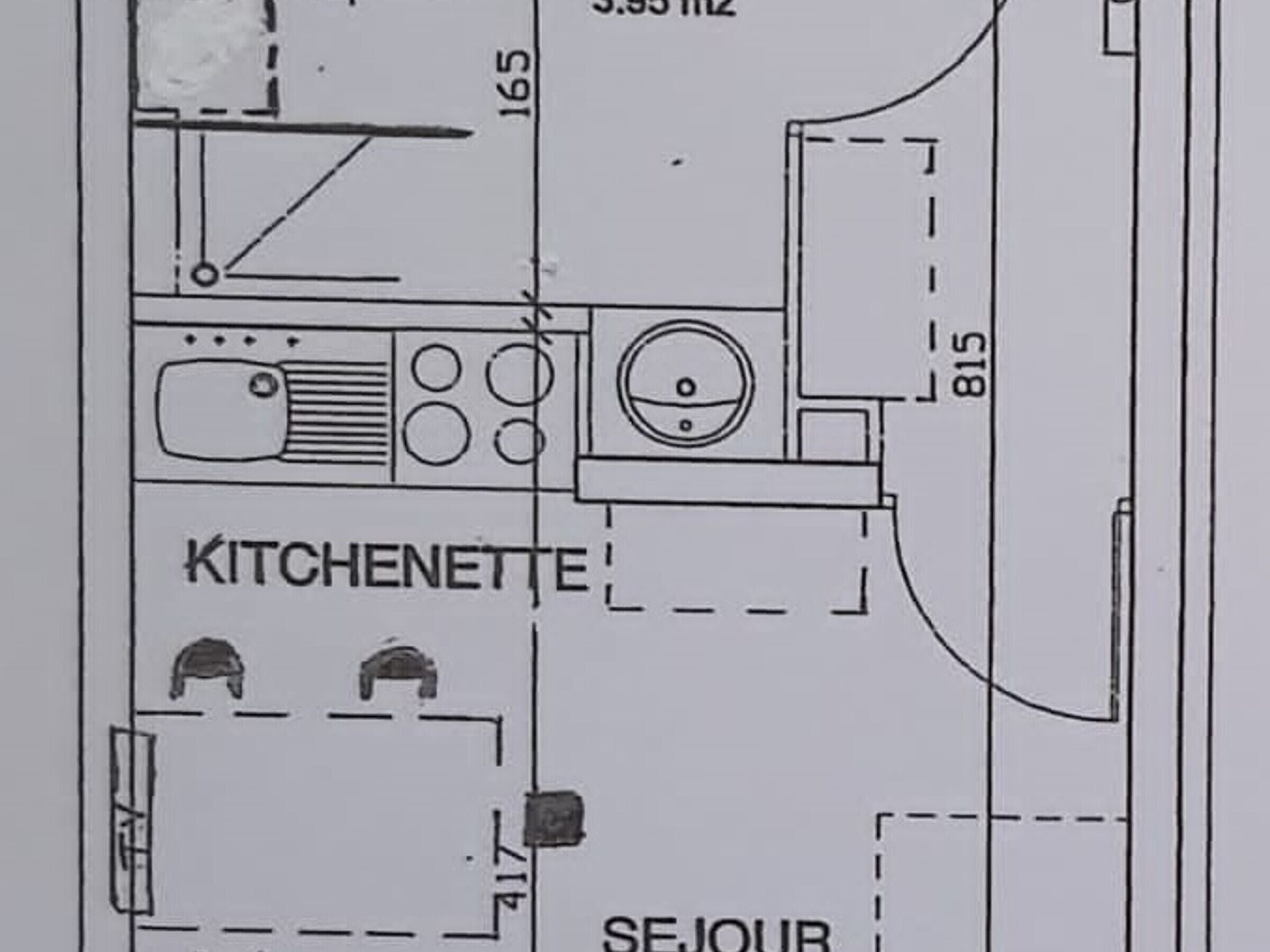 Plano de planta de una habitación de hotel con kitchenette, baño y sala de estar.