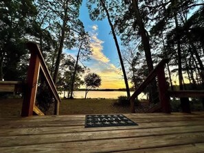 A wooden deck with a view of a lake and trees. - Lakefront Bliss | Kayaks • Paddleboards • Fire Pit • Snowbird Specials (Melrose)