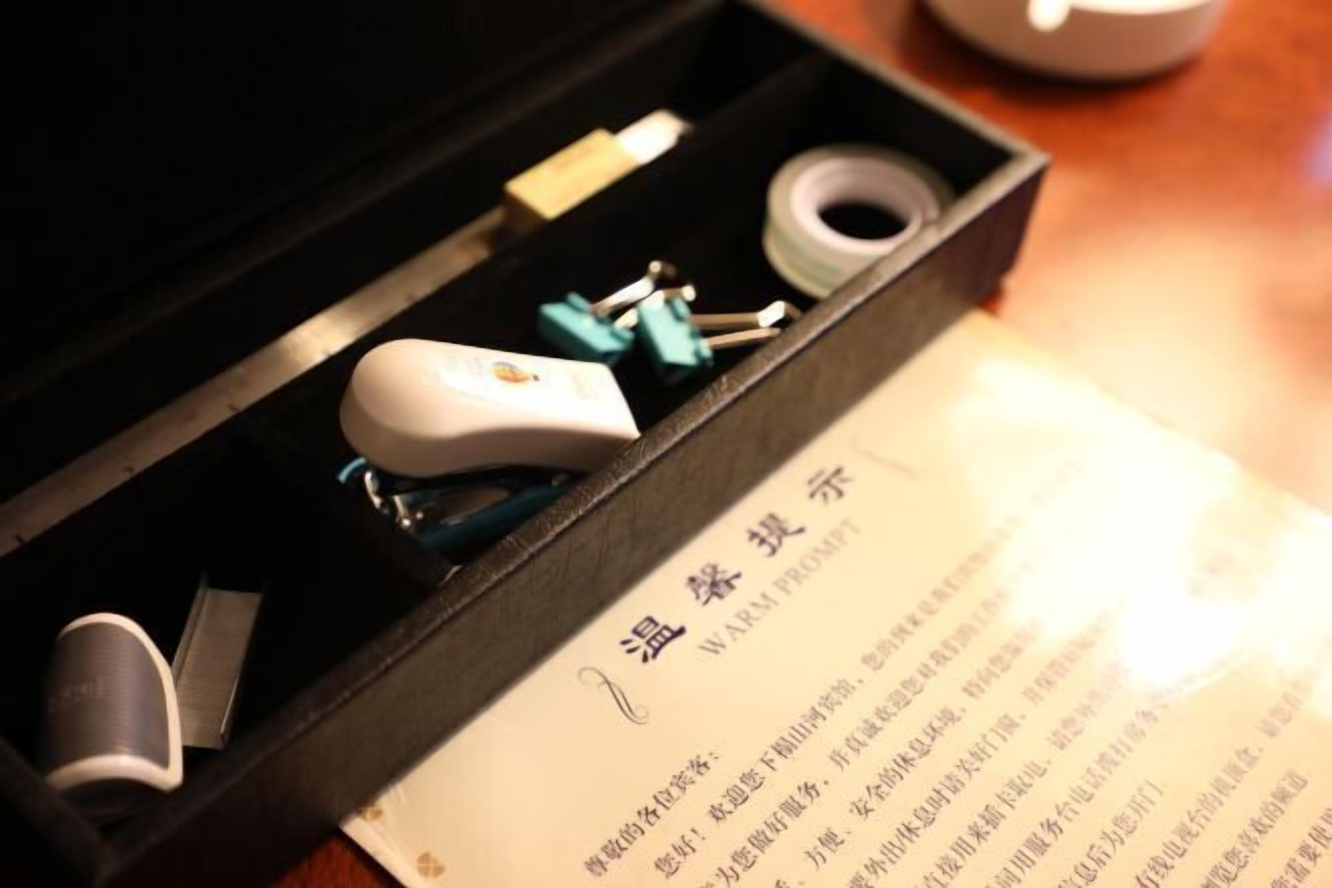 A black box containing various electronic components and a printed document with text.