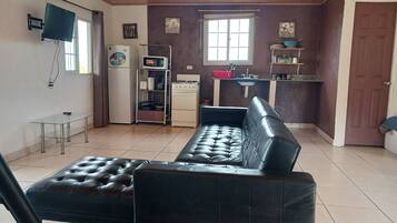 Family Studio, Balcony, Mountain View | Living area | 32-inch Smart TV with cable channels