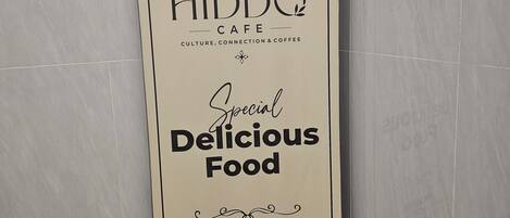 Cartel vertical para el café Hiddq, con logotipo, nombre e información de contacto.