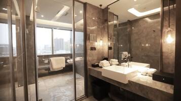 A modern bathroom with a glass shower enclosure, a large mirror, and a dual sink vanity.