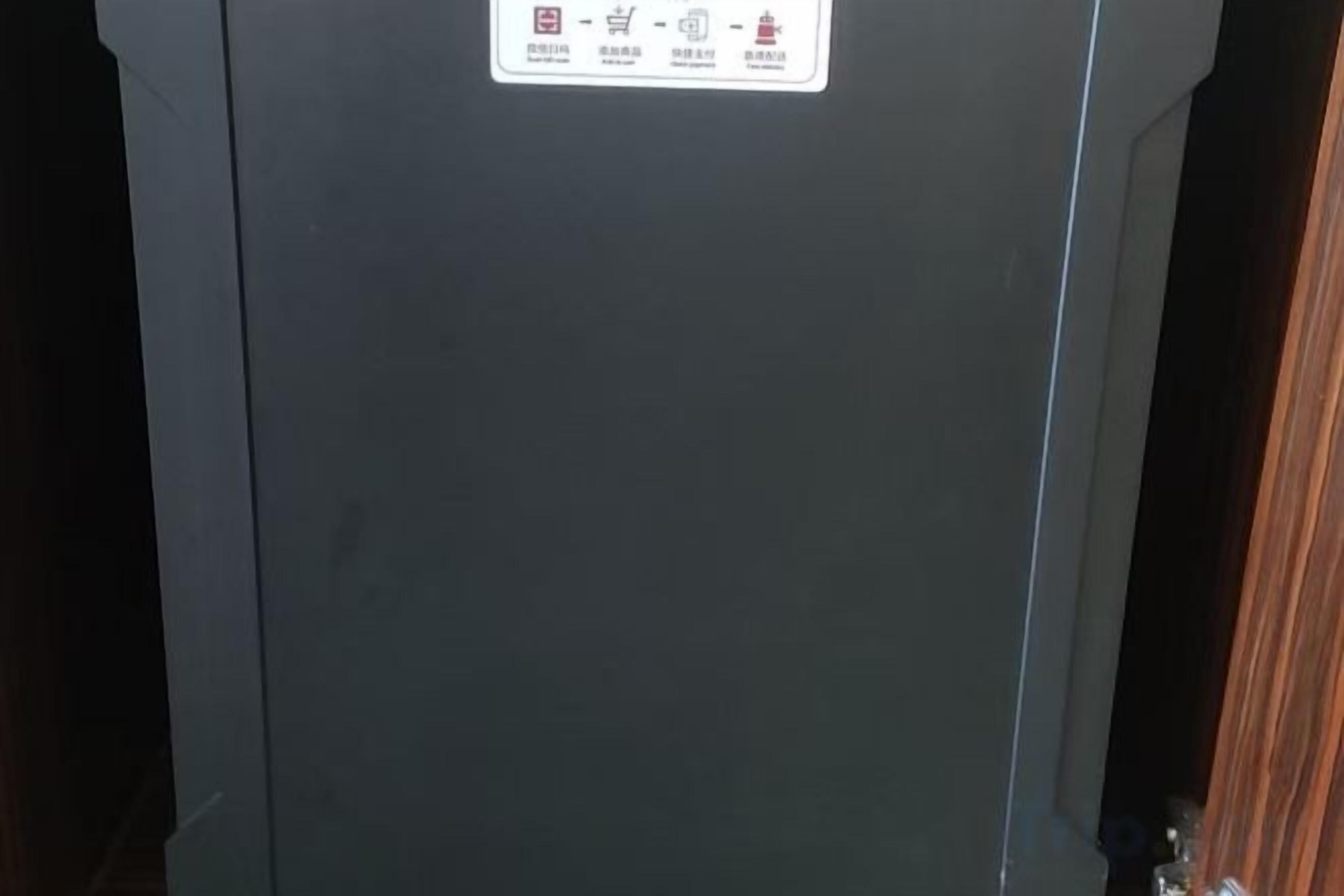 A dark-colored door with a safety warning label.