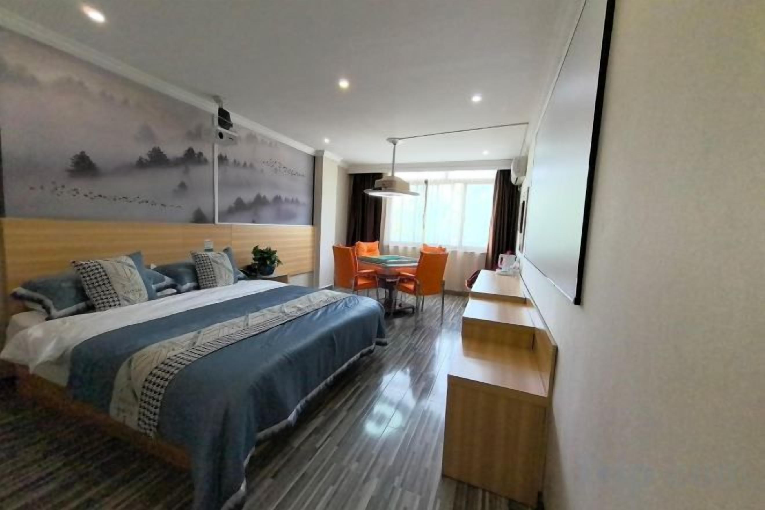 Een hotelkamer met een bed, een bureau, een stoel en een televisie.