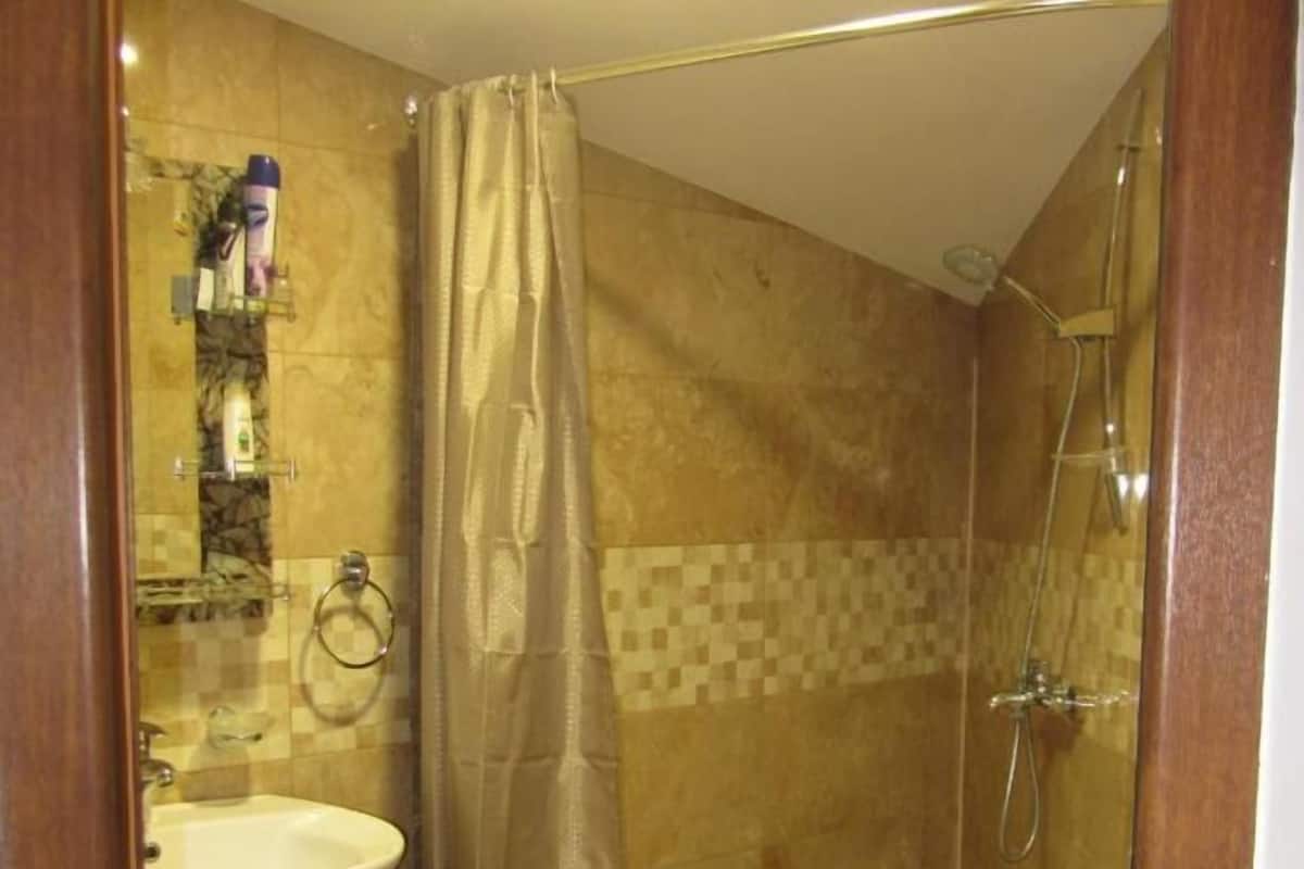 A bathroom with a shower, toilet, and sink.