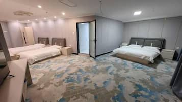 A hotel room with two beds, a large mirror, and a patterned carpet.