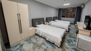 A hotel room with two beds, a wardrobe, a desk, and a window with curtains. - Zihao Hotel (Hunchun Yifen) (Hunchun)