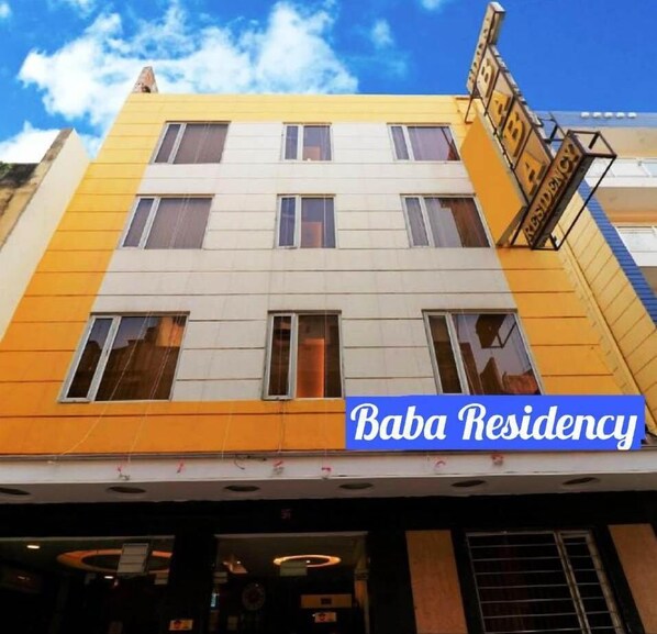 A multi-story building with a yellow and white facade, labeled "Baba Residency." - Hotel Baba Residency (New Delhi)