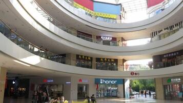 A multi-level shopping mall with various stores, including a visible Honor store.