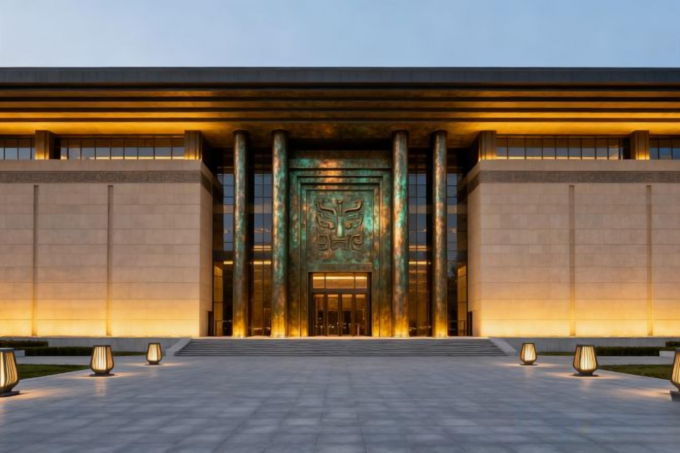 A building entrance with a large, illuminated door and columns.