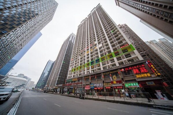 A high-rise building with multiple floors, large windows, and commercial signage.