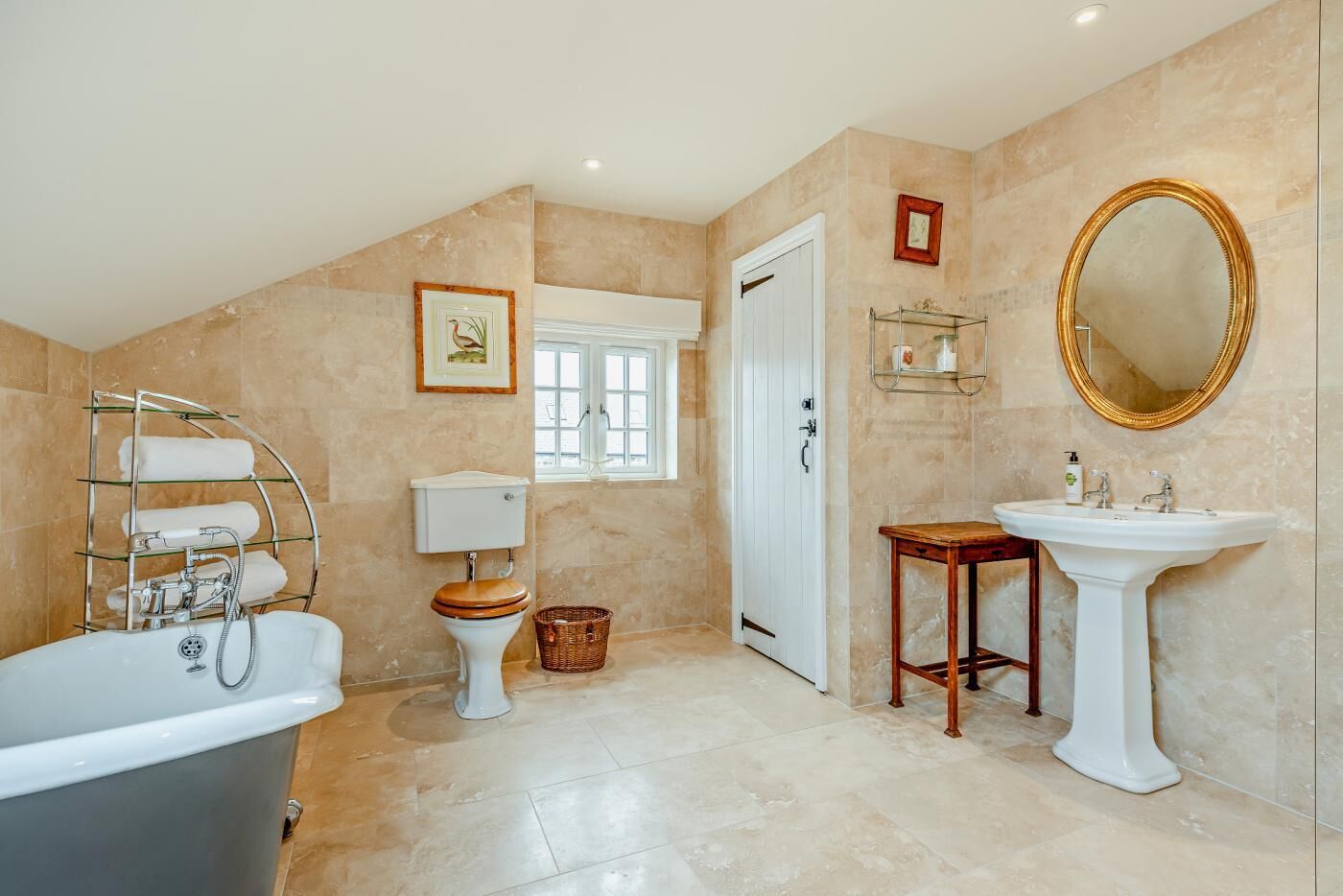 A bathroom with a bathtub, a toilet, a sink, and a shower.
