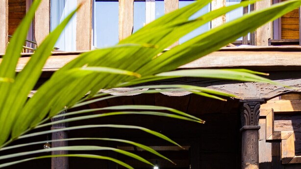 A wooden staircase leading to a room with a bed and a window. - Troje tradicional purépecha - live the experince (Morelia)