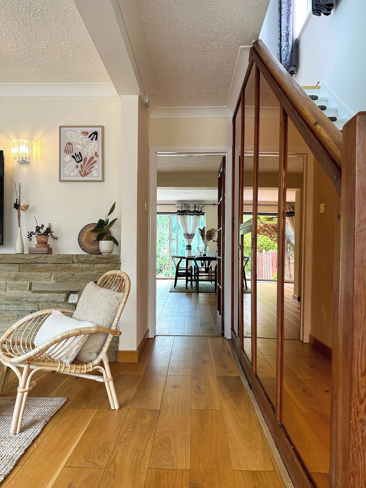 A wooden staircase leading to a dining area with a view of the outdoors.