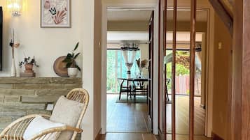 A wooden staircase leading to a dining area with a view of the outdoors.