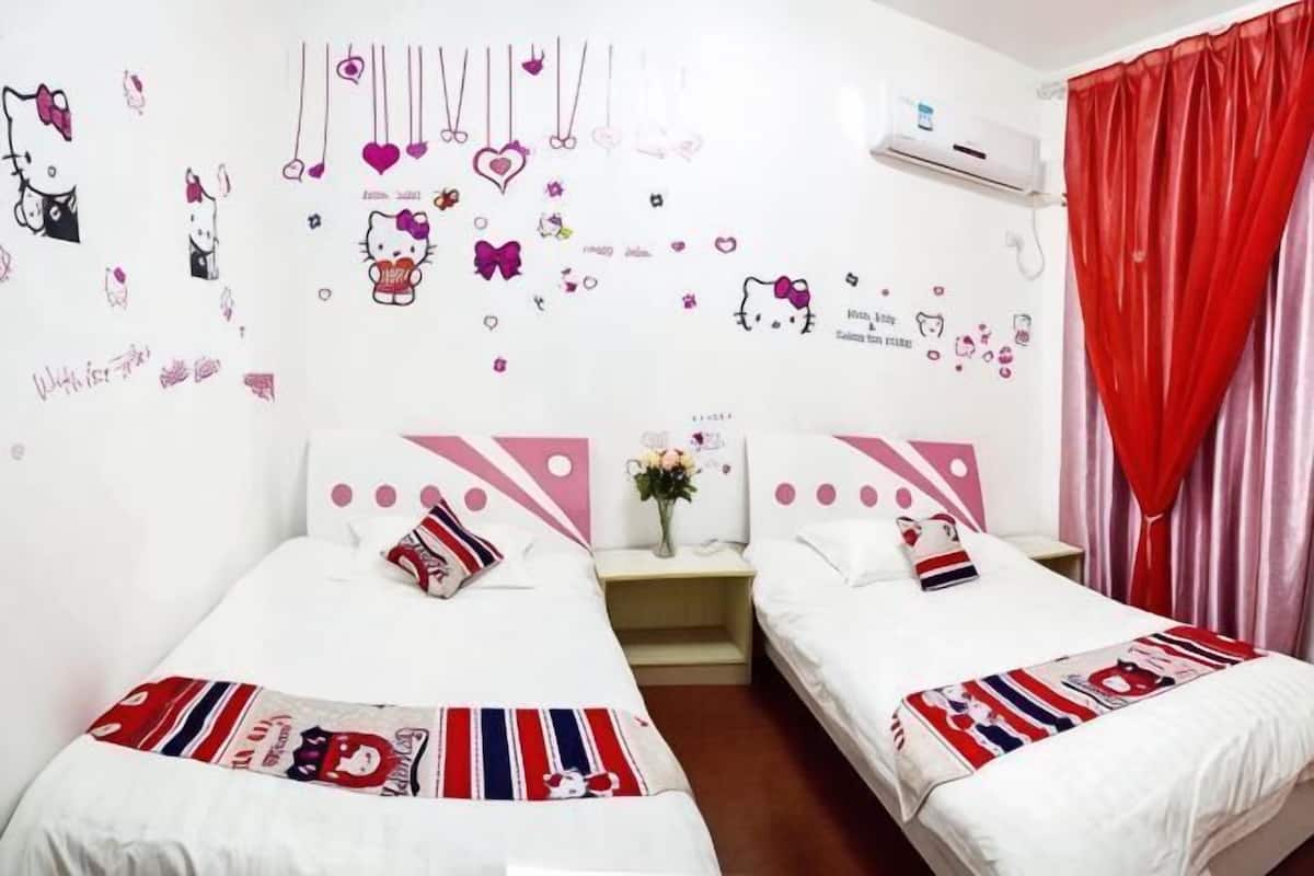 A hotel room with two beds, a nightstand, a wall decoration, and a red curtain.