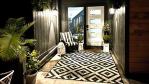 A narrow hallway with a patterned rug, a bench, and potted plants. - Marvelous Modern Spacious 4-bedroom house  near interstate and Top Golf.  (Omaha)