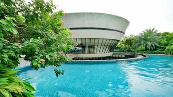 A swimming pool with a modern building in the background.