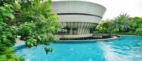 A swimming pool with a modern building in the background.