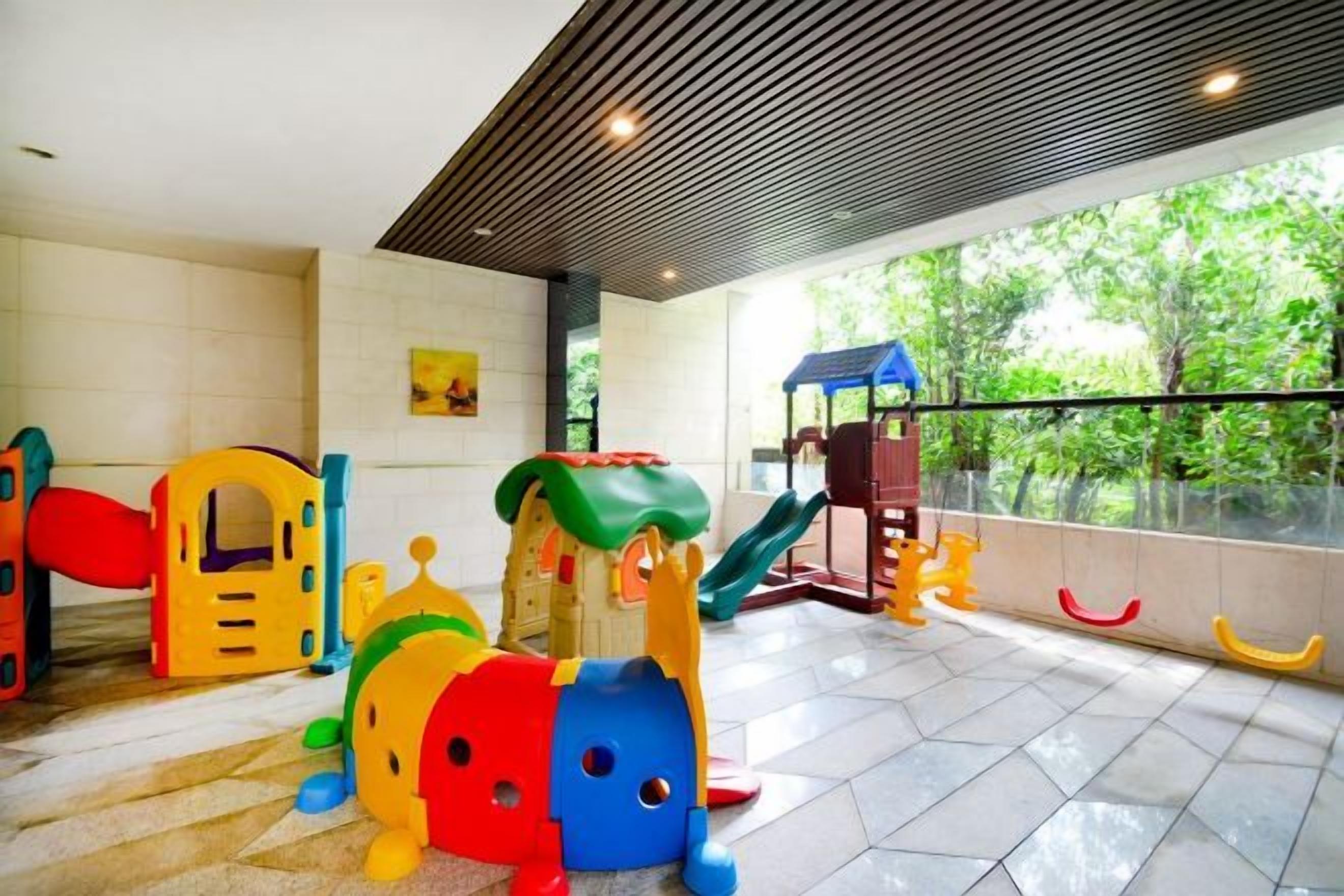 A children's play area with various play structures and a slide.