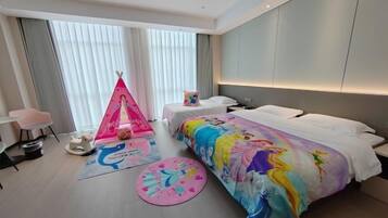 A hotel room with a large bed, a small desk, a chair, a tent, and a window with curtains.
