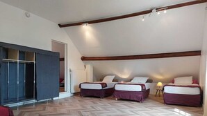 A bedroom with two beds, a wardrobe, and a radiator. - Beautiful country house located in Eure-et-Loire in an idyllic setting (La Bazoche Gouet)