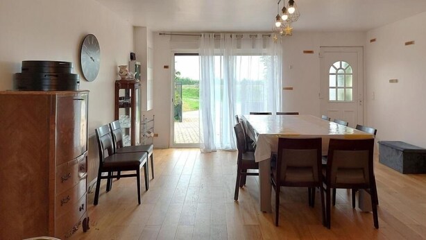 A spacious kitchen with a dining area, a large window, and a view of the outdoors. - Beautiful country house located in Eure-et-Loire in an idyllic setting (La Bazoche Gouet)