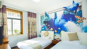 A hotel room with two beds, a large mural of a dolphin and underwater scene, a window with curtains, and a plant on the windowsill. - Caiyuan Bihai Yuntian Hotel (Shengsi)