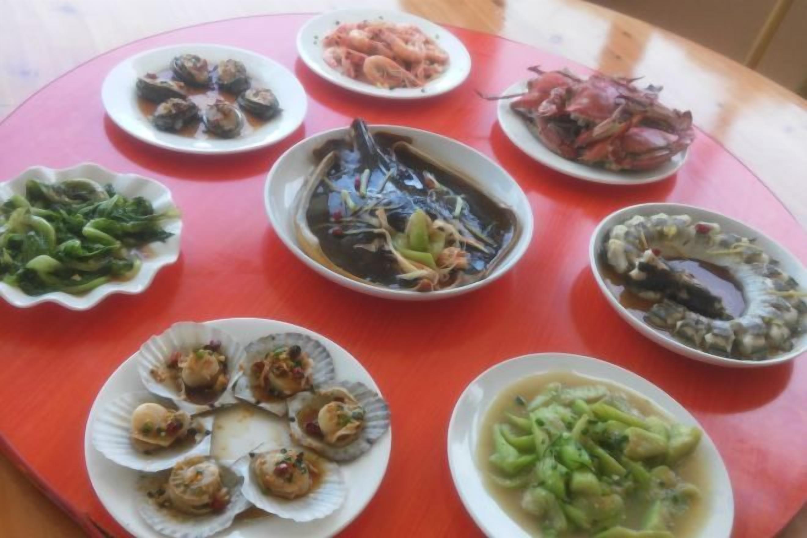 A table with various dishes, including seafood and vegetables.