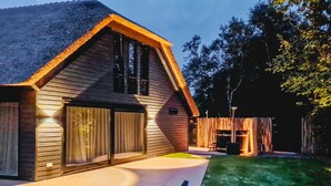 A modern house with a sloped roof, large windows, and a well-lit exterior. - Pet friendly home in Ballum with sauna (Ballum)