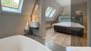 A modern bedroom with a large bed, a built-in wardrobe, and skylights. - Pet friendly home in Ballum with sauna (Ballum)