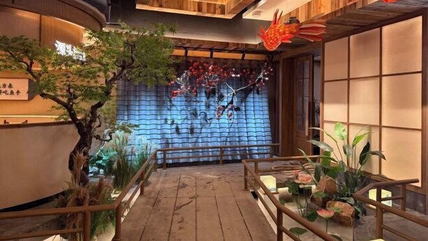 A wooden interior with a decorative wall, plants, and a railing. - Yilin International Hotel (Hefei)