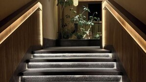 A staircase with wooden walls and a light fixture at the top. - Yilin International Hotel (Hefei)