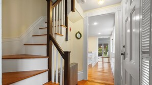 A staircase with wooden steps and a dark handrail leading to a landing. - Entire 4BR 2 Bath Home l Minutes to Downtown Salem (Salem)