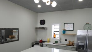 A modern kitchen with a central island, stainless steel appliances, and a pendant light fixture. - Hidden Gem in Historic Downtown Moultrie!  (Moultrie)