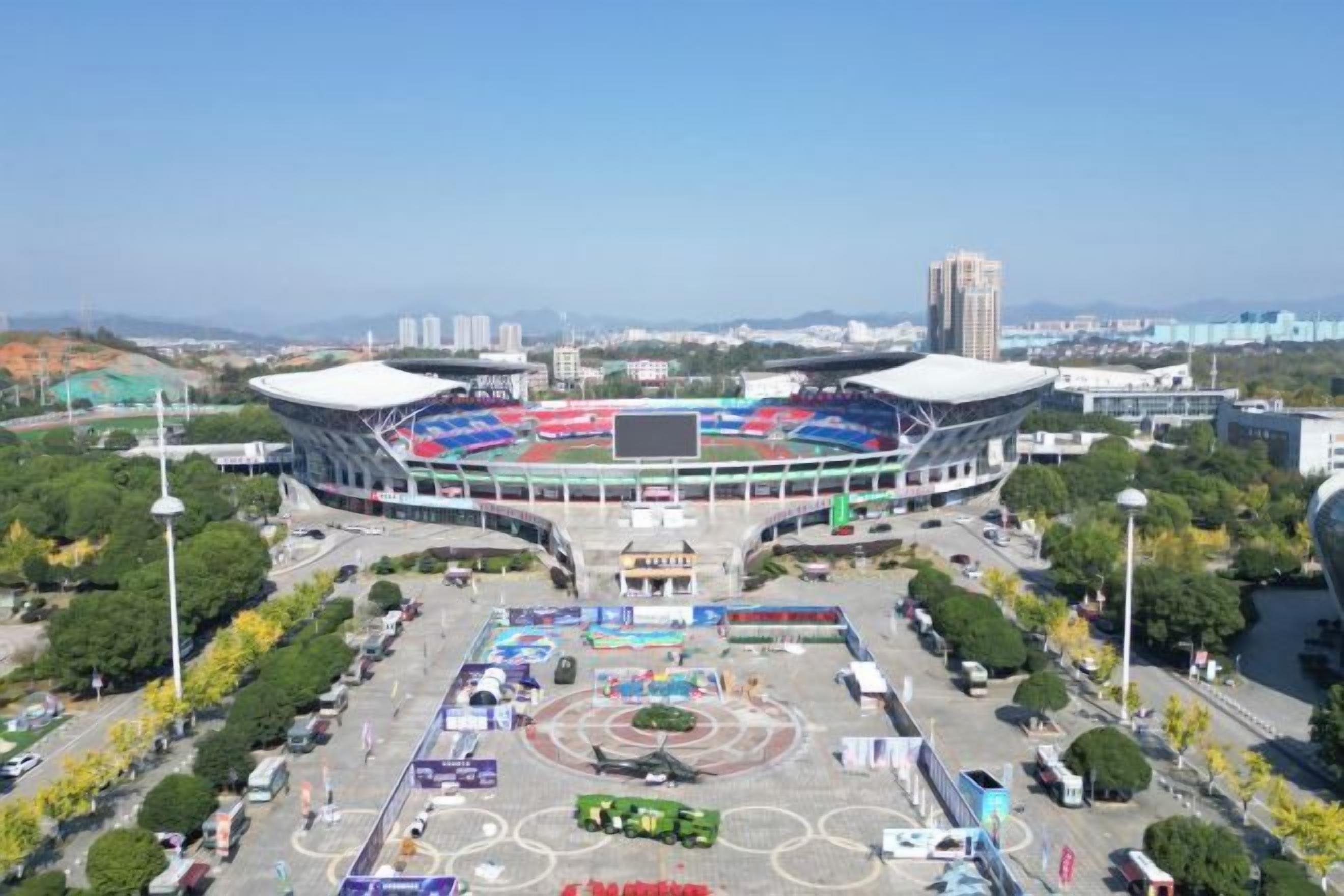 A stadium with a central field and surrounding seating.