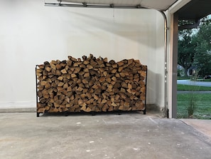 A stack of firewood in a garage. - Location! w/King Beds+Hot Tub+GameRoom+Theater+Gym+Fire Pit (Prairie Village)