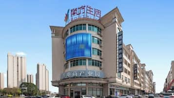 A multi-story building with a prominent sign at the top.