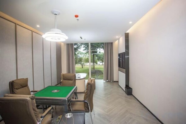 A room with a pool table, comfortable seating, a television, and a view of the outdoors. - Jinxin Huayuan Hotel (Shantou)