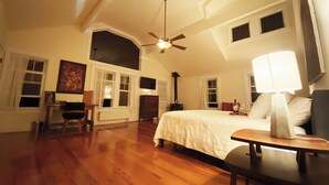 A spacious bedroom with a large bed, a desk, and a ceiling fan. - HollyKissHudsonValley Renovated 1900 Lodge, Full House. (Catskill)