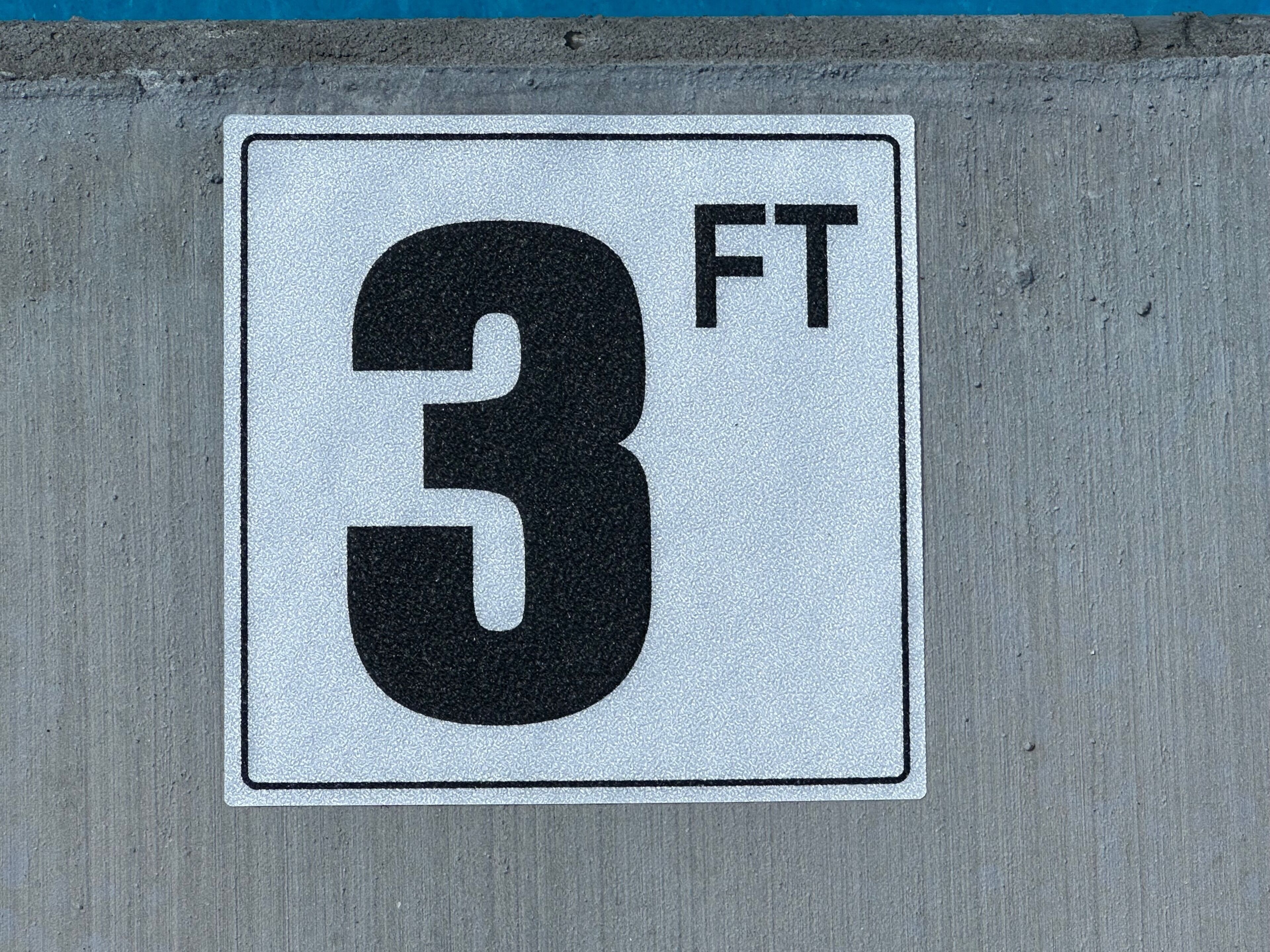 A sign with the number '3' and 'FT' indicating a measurement.