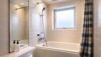 Combined shower/tub, free toiletries, hair dryer, slippers